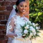 Bride Rhian wearing her bespoke silk crepe satin and lace wedding dress, handcrafted in London